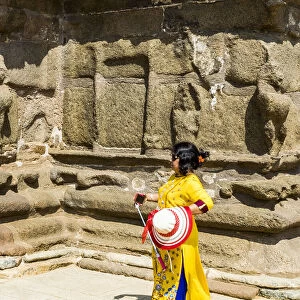 A visitor walking beside Shore Temple at Mamallapuram in Tamil Nadu, India