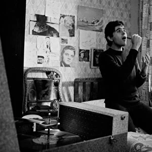 Jim Maclaine practices singing in his bedroom