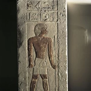 Ancient Egyptian limestone relief with figure of deceased holding sceptre and staff from Tomb of Iry, Old Kingdom, IV Dynasty