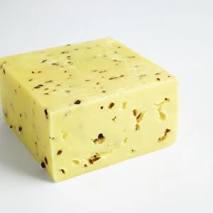 Block of Norwegian Nokkelost cows milk cheese with cumin seeds and cloves
