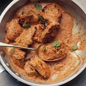 Chicken tikka masala in pan with spoon