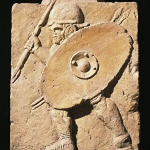Column base with relief portraying legionnaire armed with pilum and with round helmet and oval shield, from Mainz, Germany