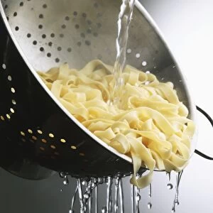 Draining and rinsing pasta in a colander