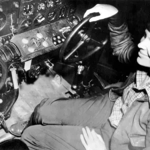 Amelia Earhart Print: Photograph of Amelia Earhart at control panel Amelia Earhart Print: Photograph of Amelia Earhart at control panel