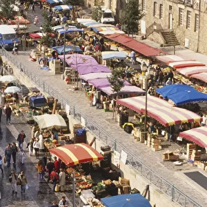 France, Britanny, Place des Lices in Rennes, street lined with colourfully canopied market stalls, elevated view