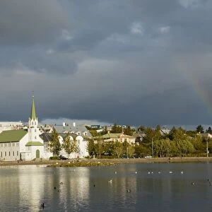 Iceland, Reykjavik, rainbow over Tjornin Lake