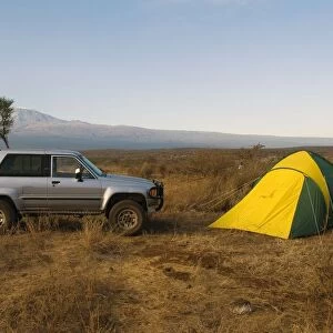 Kenya, near Amboseli National Park, Satao Elerai Camp, tent and van with Mount Kilimanjaro in the distance