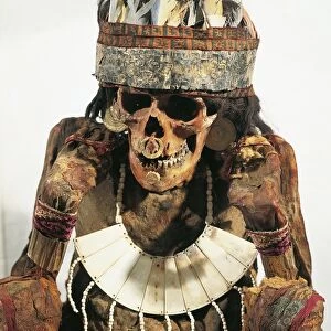 Mummy of woman of Necropolis decorated with gold and bone jewels and feather headdress, circa 200 B. C