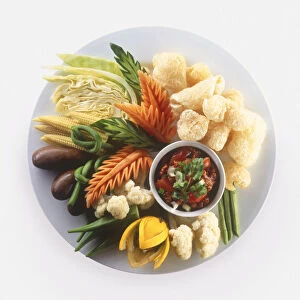 Nam Phrik Ong, pork crackling and raw vegetables served with chilli dip on a plate, a typical dish from Northern Thailand, view from above
