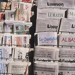 North Africa, Morocco, newspaper vendors display with newspapers in Latin and Arabic script, close up
