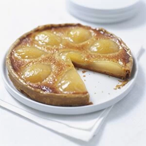 Pear tart Bourdaloue with a slice removed, close up