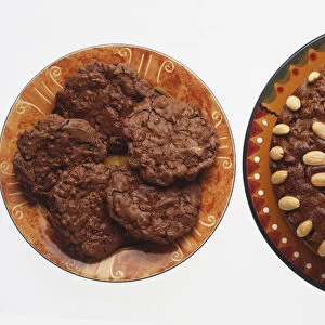 Pecan cake garnished with nuts, and a plate of pecan cookies, view from above