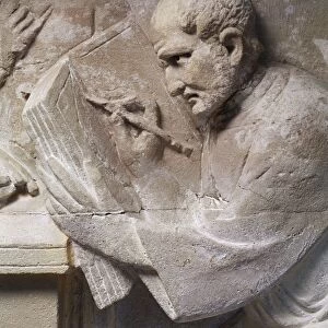 Relief from mausoleum depicting tax collector, detail, man writing on tablet with stylus