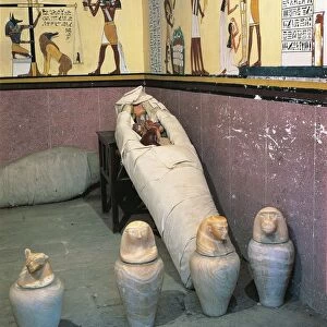 Replica of mummy chamber with four canopic jars containing viscera of deceased; liver, stomach, lungs and intestines with lids representing heads of Amset, Hapi, Qebehsenuef and Duamutef