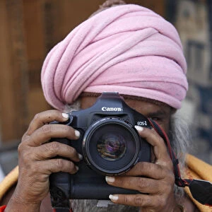 Sadhu holding a camera