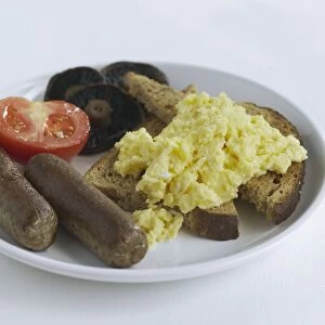 Scrambled eggs on toast with sausages, tomato, and mushrooms on plate