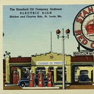 Standard Oil Gas Station. ca. 1945, St. Louis, Missouri, USA, The Standard Oil Company (Indiana) ELECTRIC SIGN Shrinker and Clayton Rds. St. Louis, Mo. STANDARD OILs HUGE ELECTRIC SIGN AND ITS DEALERs SERVICE STATION consume about the same amount of current as an average town of 1000 people. Sign is 40 ft. in diameter and 70 ft. to the top. It required 44 tons of steel and 7 1 / 2 tons of sheet metal. Has 5600 lamps and 2900 ft. of neon tubing with 87 electrical circuits and 5 miles of wire