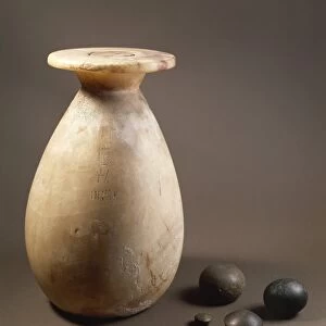 Stone weights and alabaster vase used as a measure instrument for liquids