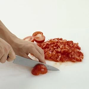 Tomatoes being diced with chefs knife