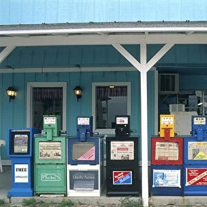 USA, Florida, Palm Beach, newspaper vending machines aligned on a veranda