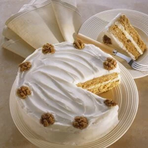 Walnut cake with icing, decorated with whole walnuts