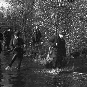 World war 2, byelorussian partisans making their way through forests and marshes
