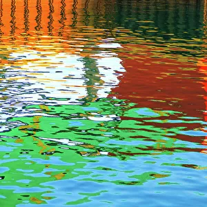 Blue, green, red, orange and brown colours reflected in the sea at the commercial dock at the Port Lincoln Wharf. Port Lincoln. South Australia
