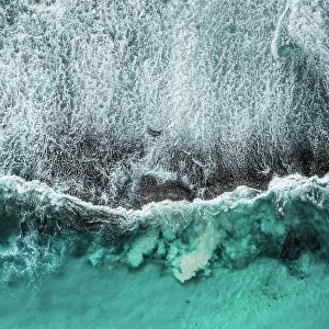 Drone photo showing Ocean waves breaking over an exposed rock formation, Twilight Bay, Esperance, Western Australia, Australia