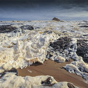 Foaming tidal sea surges, near the Arthur river estuary, west coastline of Tasmania