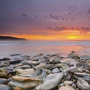 Sunrise on rocky beach