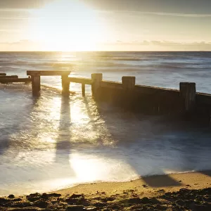 Sunset view of pier ruins at Mentone beach, Melbourne