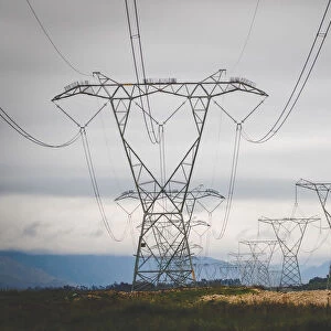 Close up image of overhead power lines sending electricity country wide