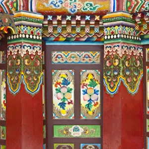 Colorful Tibetan designs on wall and columns of temple, Jiuzhaigou National Scenic Area, Sichuan Province, China