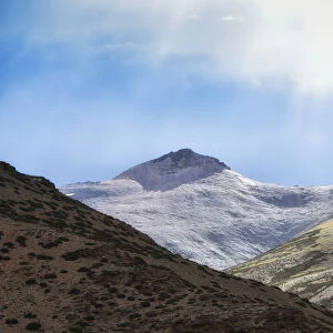 dramatic landscape sunlight on snow capped mountain peak on the way to leh ladakh, jammu and kashmir, india
