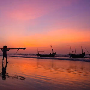 Fisherman going on the beach at dawn in Vietnam