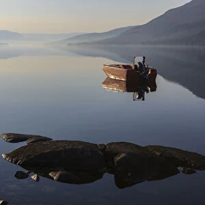 Fishing boat on Loch Arkaig in the early morning, Fort William, Highlands, Scotland, United Kingdom