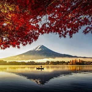 Fuji Mountain and Fisherman Boat with Morning Mist in Autumn, Kawaguchiko Lake, Japan