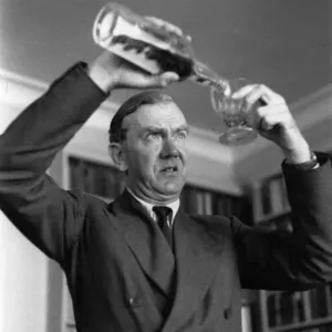 Graham Greene Pours Drink