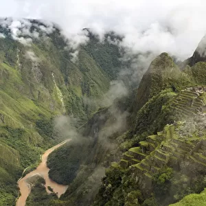 Inca ruins at Machu Picchu, UNESCO World Heritage Site, with clouds and the Urubamba River, Urubamba Valley, Andes, Peru