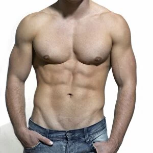 Man with a naked torso wearing a pair of jeans