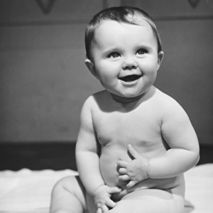 Naked baby boy (6-9 months) sitting on blanket (B&W)