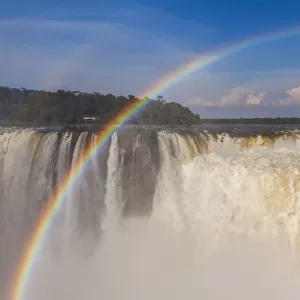 Rainbow over the Iguazu Falls at sunset