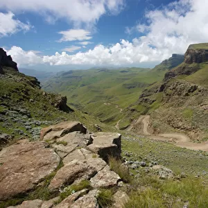A scenic view of the a trail through the hills of the Sani Pass, Drakensberg Park, KwaZulu-Natal, South Africa