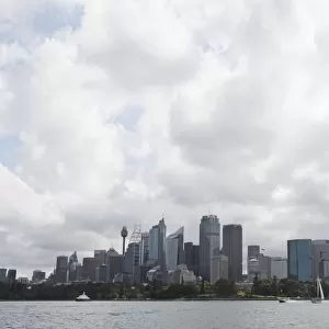 Sydney opera house and skyline against cloudy sky, Australia