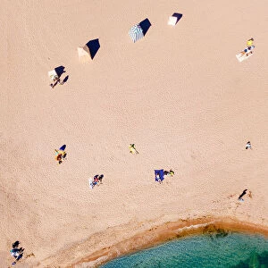 Top-down aerial view of sunbathers on a beach in Hanko, southern tip of Finland
