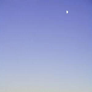 USA, South Dakota, Badlands National Park, moon over sandstone buttes