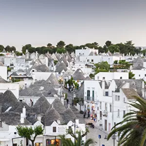 View of the Rione Monti district at dusk, trulli, traditional round houses, trullo settlement, Alberobello, Valle dItria, Trulli Valley, Apulia, Italy