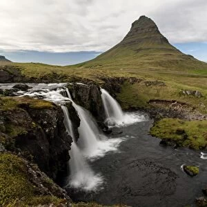Waterfall near Grundarfjordur, Kirkjufell at the back, Snaefellsnes peninsula, Iceland