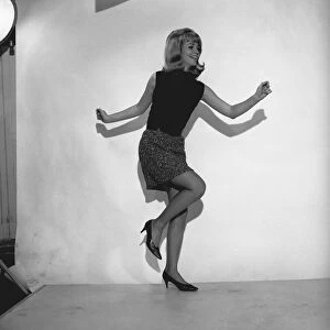 Woman dancing in studio, (B&W)