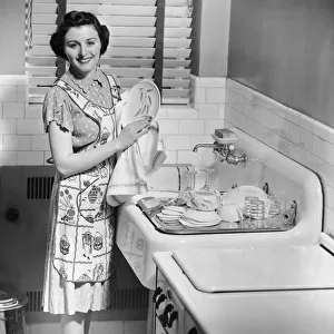 Woman at sink washing dishes